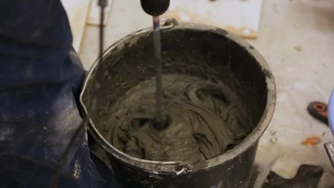 Worker mixing tile glue in bucket 스톡 동영상 128412674