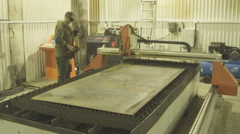 Worker monitors a machine plasma metal cutting through protective glasses Stock Footage 63997997