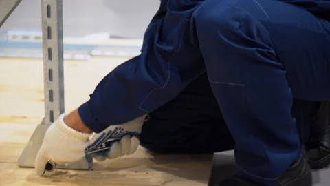 Worker mount construction. Man uses adjustable wrench, holds component part Stock Footage 126356320