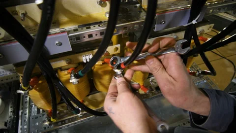 Worker mounts distribution board dividing electrical power feed Stock Footage 92016661