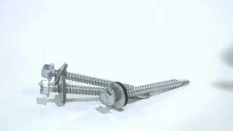 A worker mounts metal racks for shelving on a concrete wall using a cordless Stock-Footage 128929341