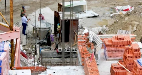 A worker mounts a wall and workers carry an oxygen tank Stock Footage 137086633