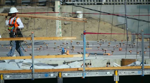 Worker moves a beam at construction site Stock Footage 34502054