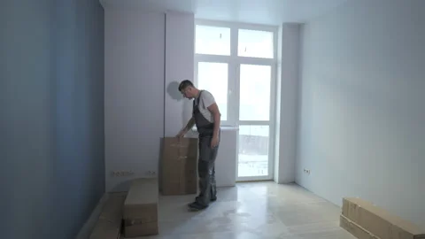 Worker moves boxes in a new apartment Stock Footage 170045759