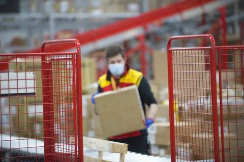A worker moving a box in Logistics center Stock Photos