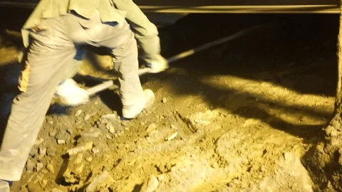 Worker moving coal ashes from the conveyor belt at an electricity plant in n Stock Footage 121811090