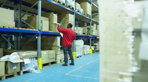 Worker moving consignment in a warehouse 스톡 동영상 32934355