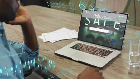 Worker moving right hand to trackpad and analyzing ecommerce sales with SALE HUD Stock Footage 333632147