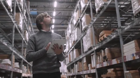 Worker moving, taking out, putting, segregating, lifting on from shelves in Stock Footage 72029390