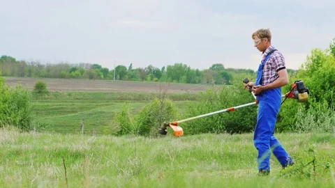 Worker Mows Green Grass Manual Lawnmower Stock Footage 75467057