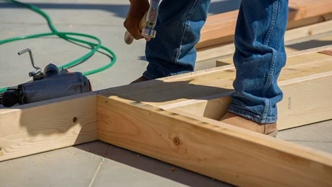 Worker Nails Framing in with Nail Gun and Hammer Stock Footage 80832866