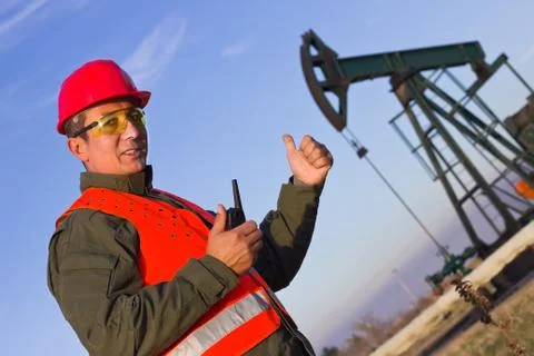 Worker on an oil rig elevated thumbs Stock Photos