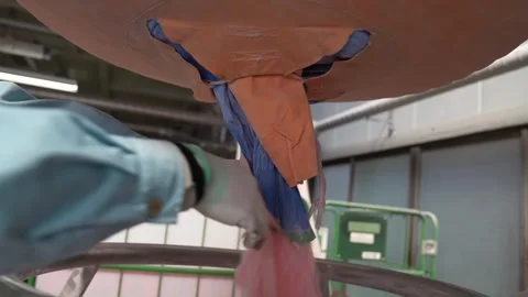 Worker opens bulk bag to pour pink dry chemical extinguishing powder into Stock Footage 347719825