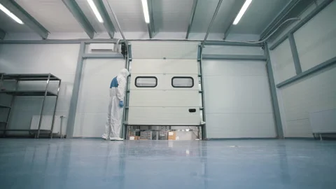 A worker opens a department in a warehouse Stock Footage 145688914