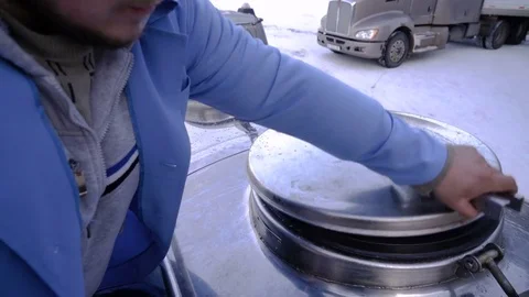 Worker opens the hatch of the milk truck. The process of filling the milk tanker Stock Footage 75041110