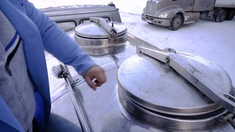 Worker opens the hatch of the milk truck. The process of filling the milk tanker Video stock 75041216