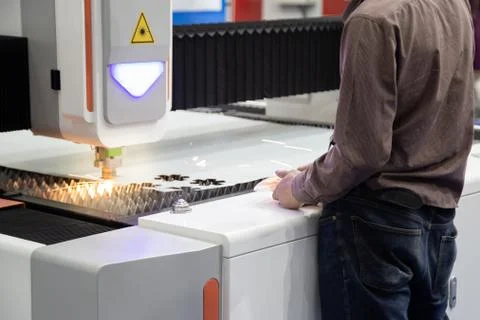 Worker operate CNC laser cutting machine Stock Photos