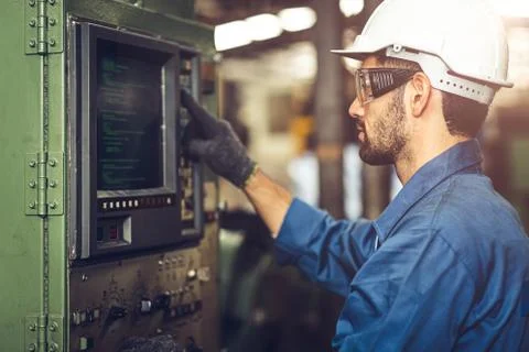 Worker operate CNC machine with G-Code monitor, high skill labor work industr Stock Photos