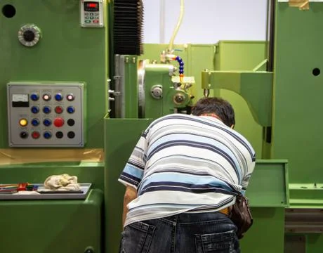 Worker operate CNC machine Stock Photos