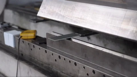 Worker operates bending machine in a metal construction company Stock-Footage 83615065