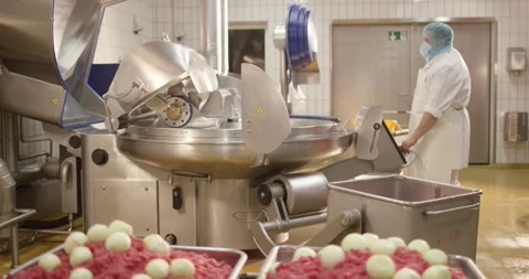 Worker operates large bowl cutter in meat plant, Food Factory Stock Footage 340004190