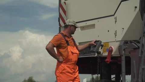 A worker operates the milling machine control panel while driving Stock Footage 145466043