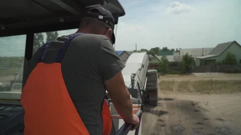 A worker operates the milling machine control panel while driving Stock Footage 145466066