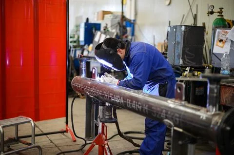 Worker operating an angle grinder and making lots of sparks Photos