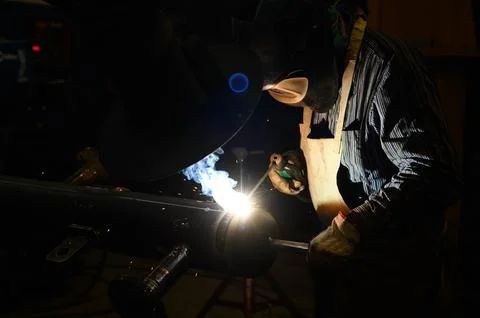 Worker operating an angle grinder and making lots of sparks 写真素材