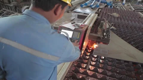 Worker Operating CNC Plasma Cutting Machine for Heavy Steel Stock Footage 341844790