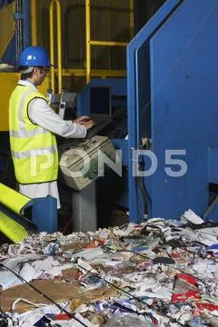 Worker Operating Conveyor Belt In Recycling Factory Stock Photos