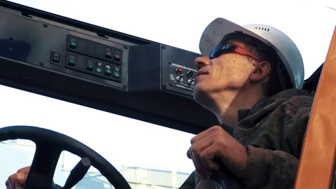 Worker operating a crane at a construction site Stock Footage 89873048