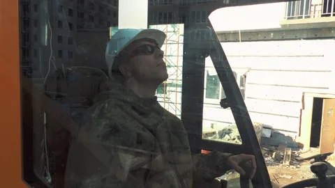 Worker operating a crane at a construction site Stock Footage 89873050