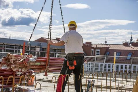 Worker operating a crane in a production facility. 스톡 사진