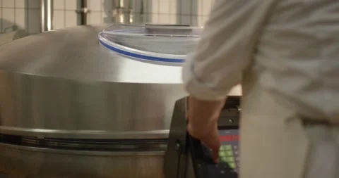 Worker operating industrial cooking kettle in sausage plant, Static Shot Stock-Footage 340006091