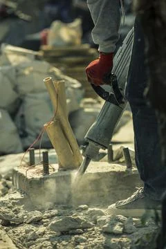 Worker Operating a Jackhammer on Construction Site Stock Photos