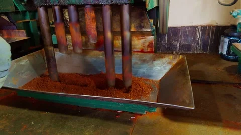 Worker operating machinery for grinding red chilli processing chilli powder.. Stock Footage 264938985