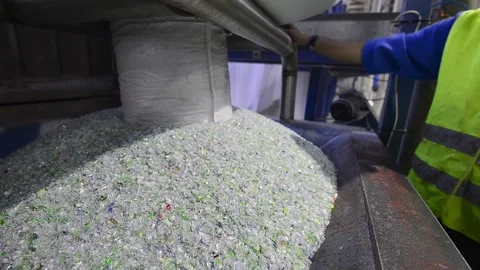 Worker operating machinery in a plastic recycling factory Stock Footage 332650176