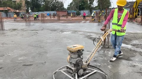 Worker Operating Power Float Machine to Finish Fresh Concrete Floor Stock Footage 344562029
