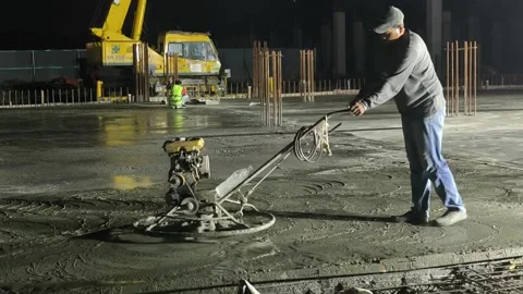 Worker Operating Power Float Machine to Finish Fresh Concrete Floor Stock Footage 344562265