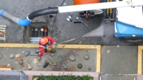 Worker operating pressure washer Stock Footage 72135496