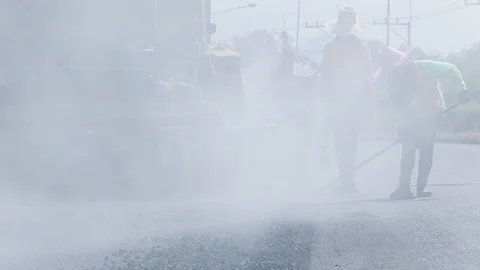 Worker operating the process of building new asphalt road Stock Footage 87022986