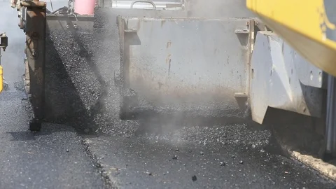 Worker operating the process of building new asphalt road Stock Footage 87023154