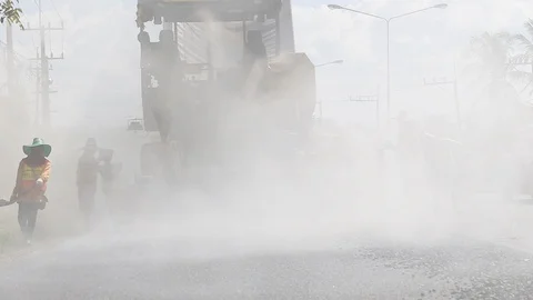 Worker operating the process of building new asphalt road Stock Footage 87023239