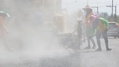 Worker operating the process of building new asphalt road Stock Footage 87023273