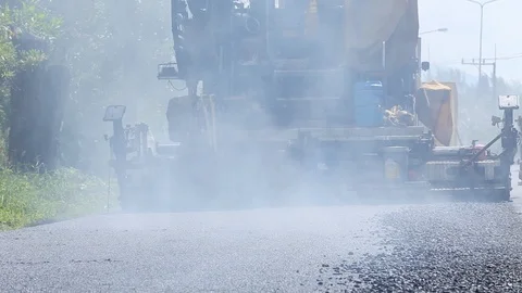 Worker operating the process of building new asphalt road Stock Footage 87023439