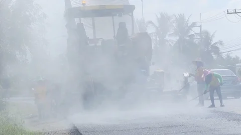 Worker operating the process of building new asphalt road Stock Footage 87023509