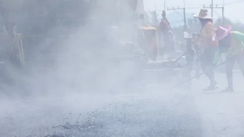 Worker operating the process of building new asphalt road Stock Footage 87023616