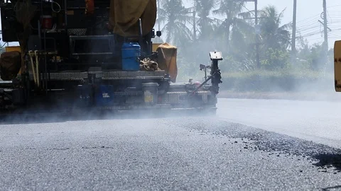 Worker operating the process of building new asphalt road Stock Footage 87023661