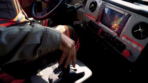 Worker operating a red emergency stop button with dashboard controls and shifter Video stock 331791271
